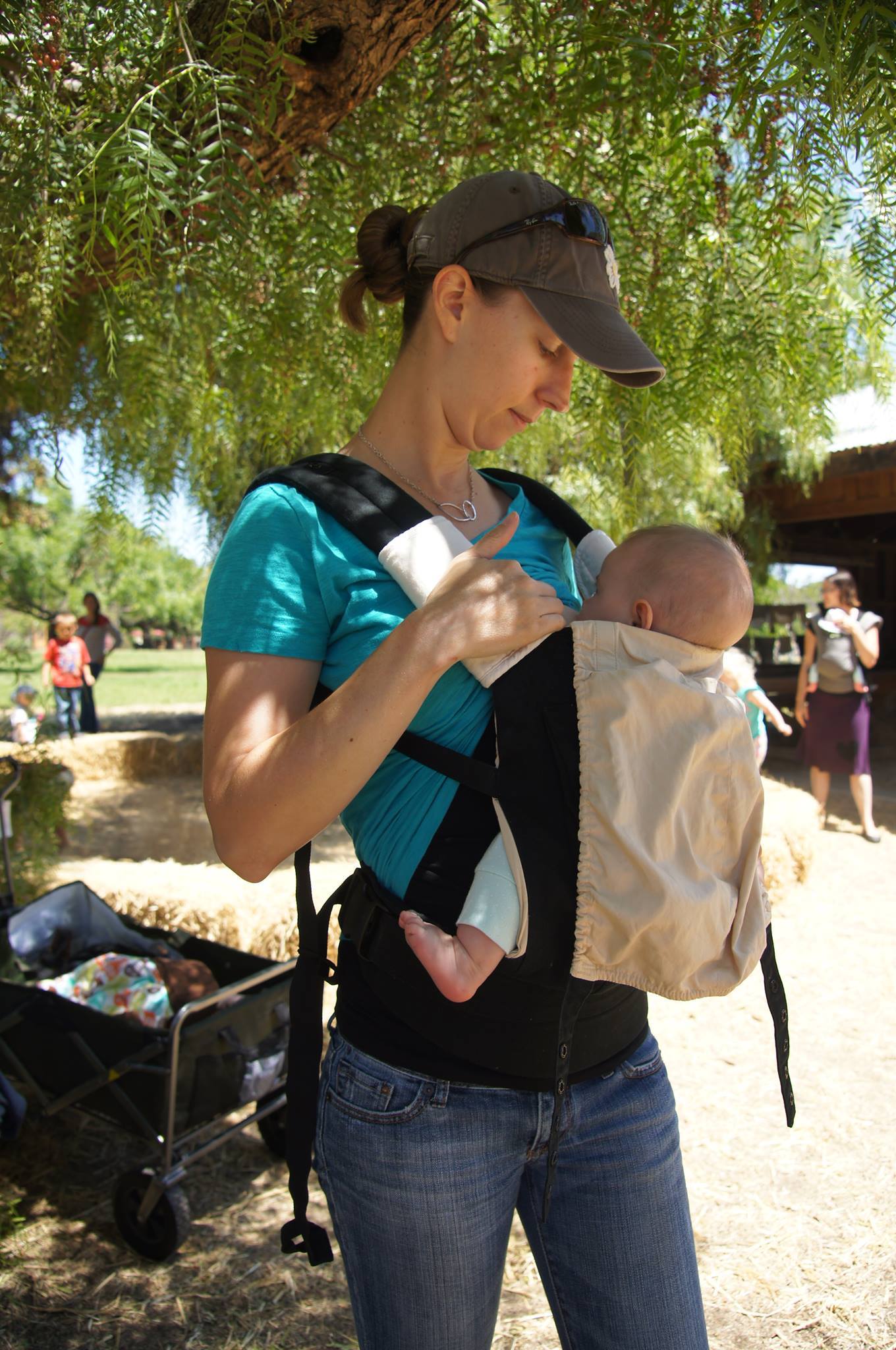 breastfeeding newborn in ergo baby carrier